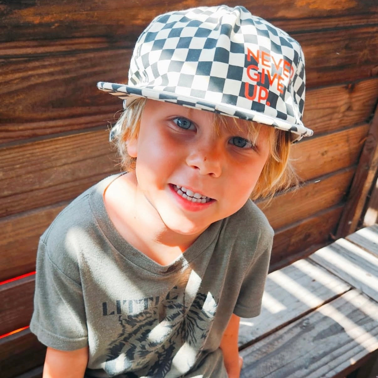 NEVER GIVE UP. BLACK CHECKERED HAT